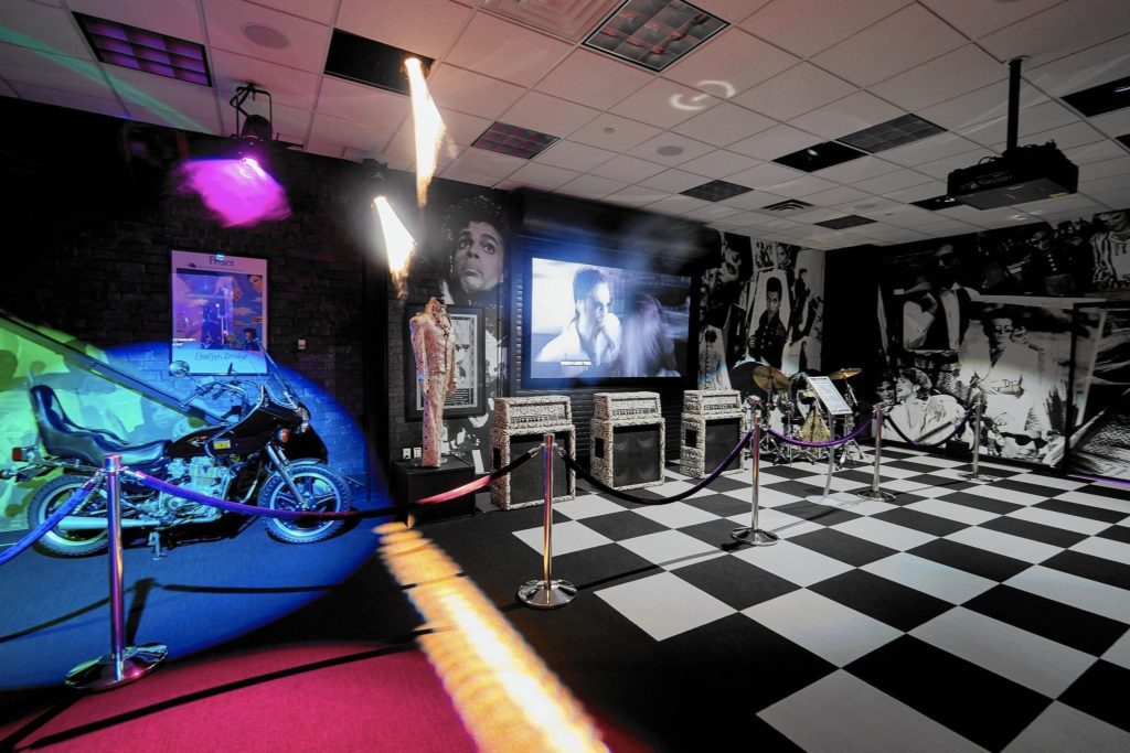 Paisley Park Themed Room featuring Graffiti Bridge and Parade albums.